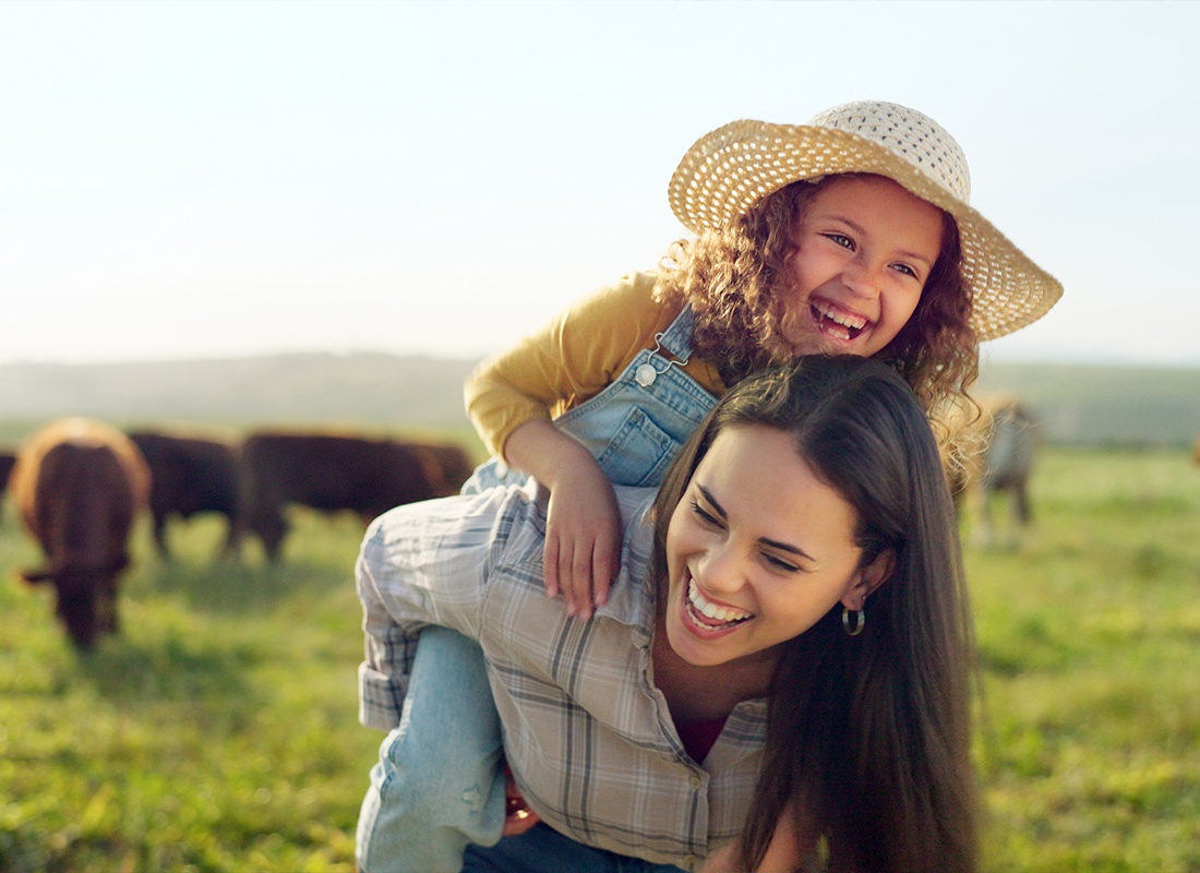 Personal Insurance - Mother and Daughter Playing Around and Having Fun in a Farm